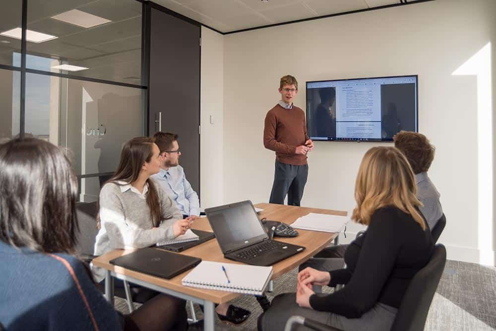 Corporate Photography Reportage - Presenting to team in meeting room