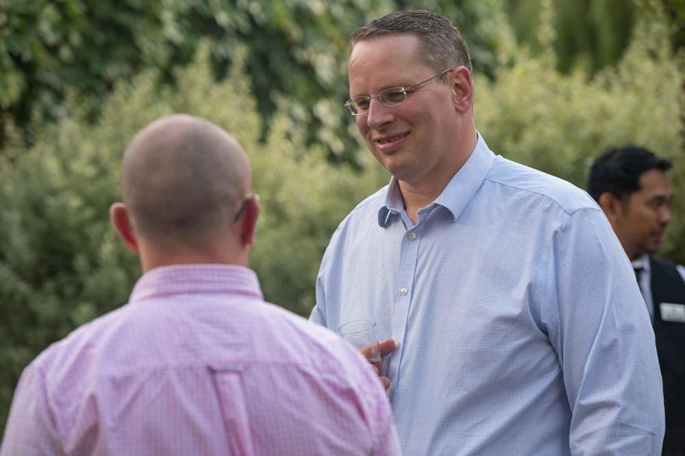 Business networking outdoor photographs of professionals at corporate event in UK.