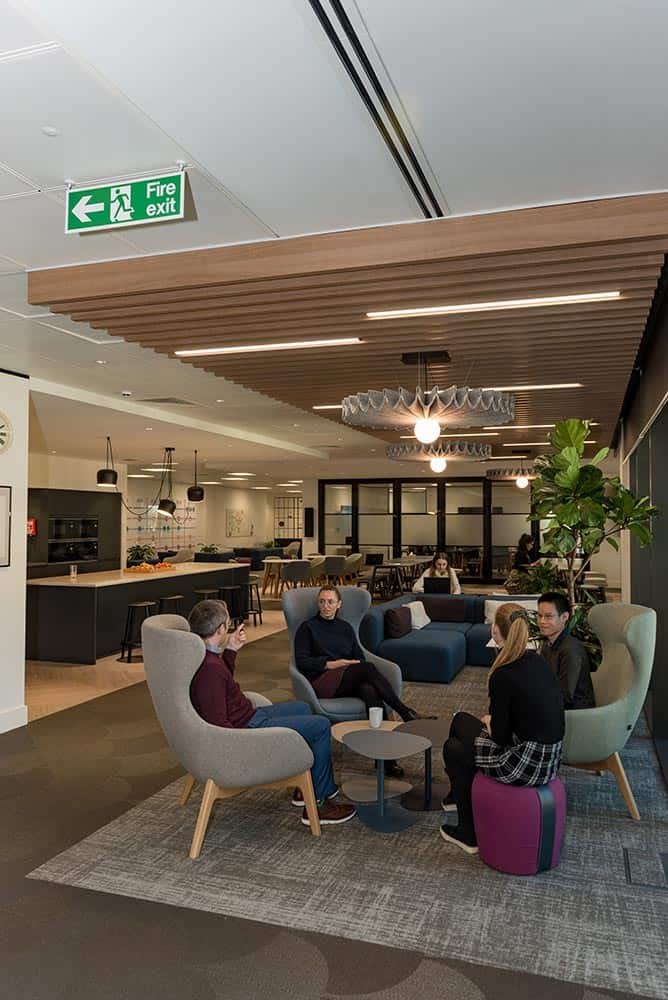 Why Custom Stock Photography Beats Generic Images 5 Modern corporate lounge with team members in a professional meeting space.