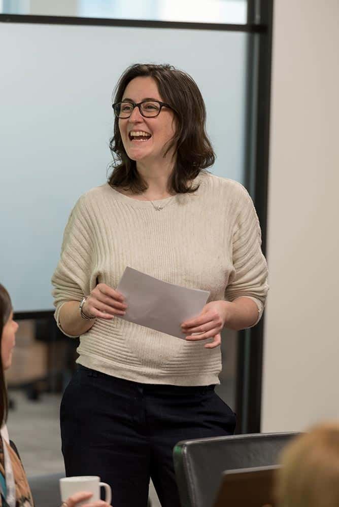 Why Custom Stock Photography Beats Generic Images 7 Confident female professional giving presentation in corporate office.