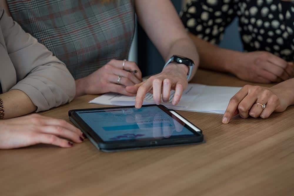 Why Custom Stock Photography Beats Generic Images 12 Collaborative business meeting with digital tablet, corporate photography for professional team shot.