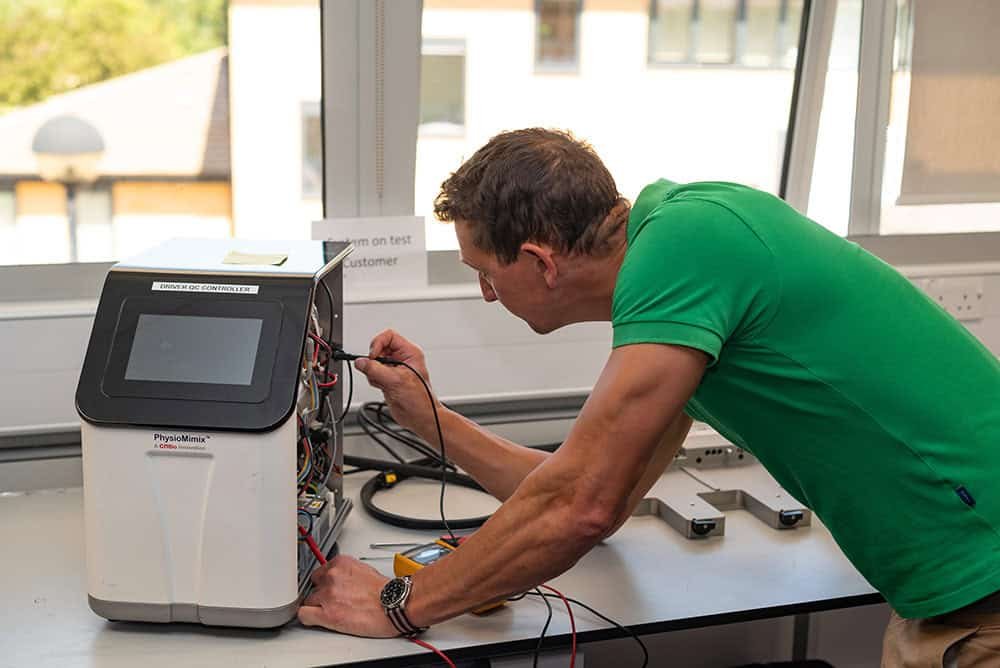 Capturing Innovation: Photography for Research Companies 2 Engineer conducting technical test with medical equipment in a modern office setting.