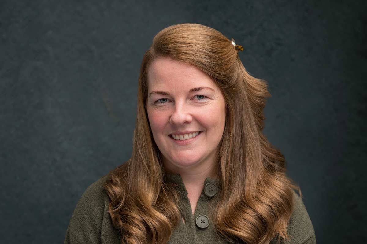 Corporate Headshots Cambridge 9 Bright red-haired woman professional headshot for corporate photography.