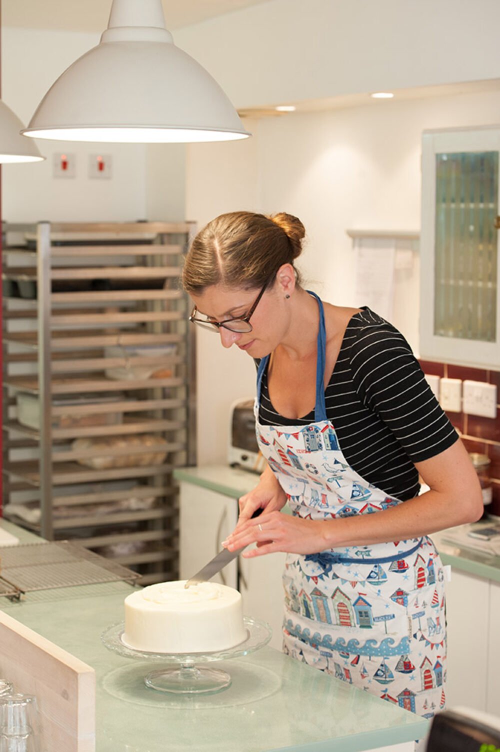 Cambridge cake-shop owner icing a cake — Afternoon Tease.