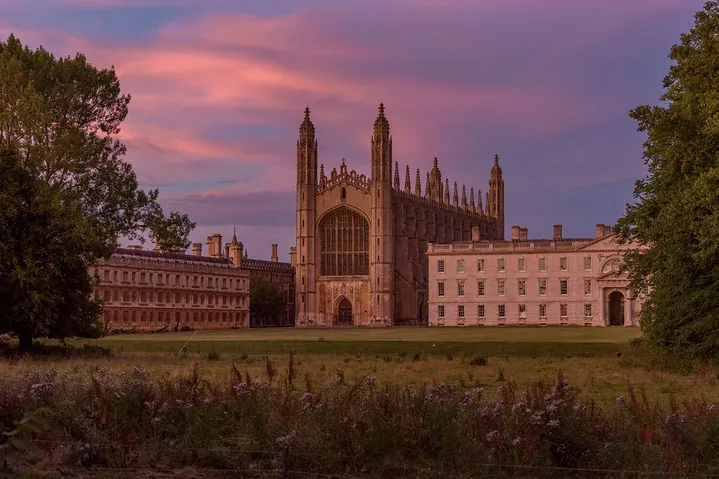 King's College Chapel, Cambridge, viewed across the Backs at dusk beneath a pink and purple sky — stock photography by Jean-Luc Benazet.