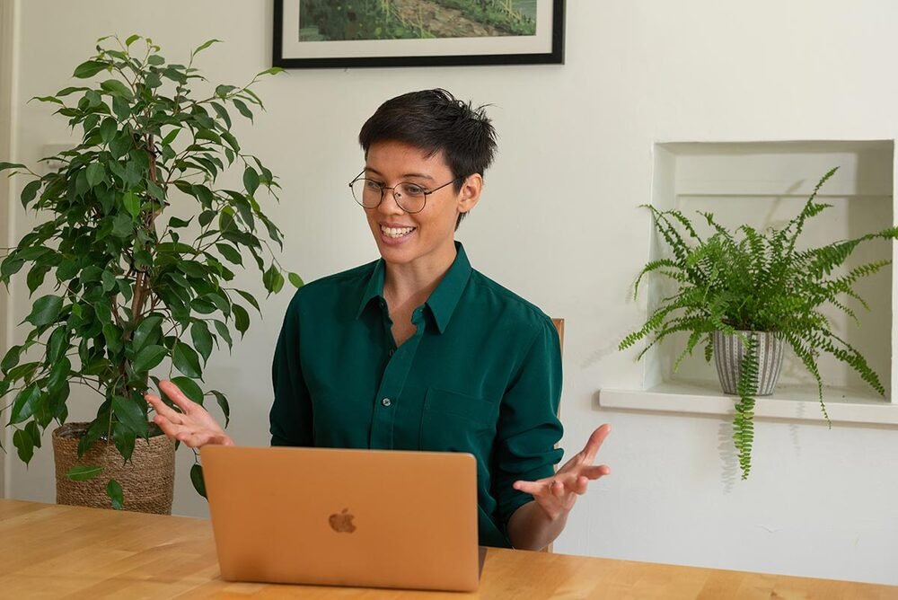 Personal brand photography — consultant at her laptop, Cambridge.