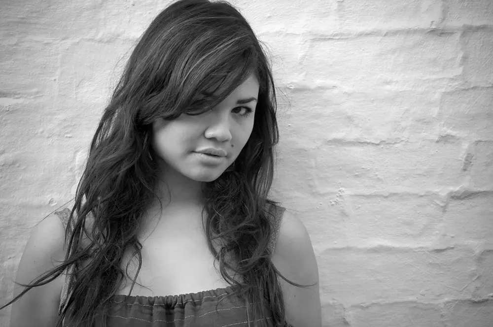 Black-and-white artist portrait with an editorial documentary feel