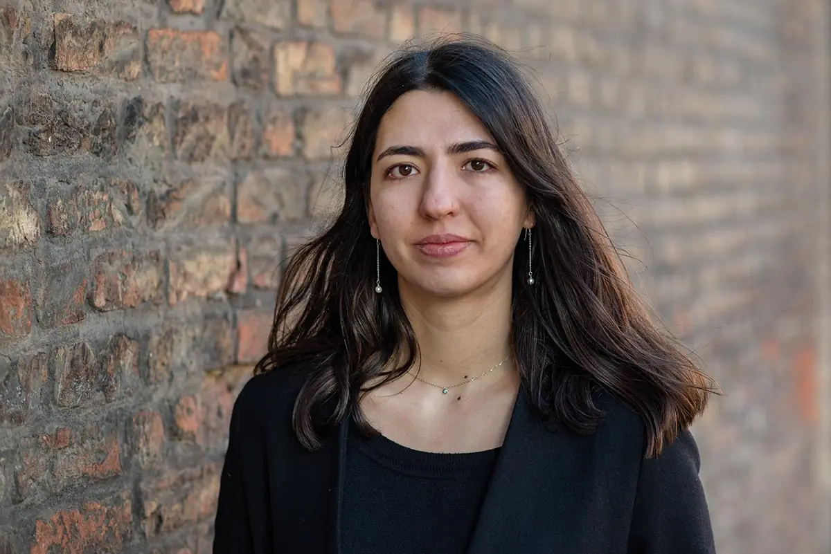 Editorial professional portrait photographed against an architectural background